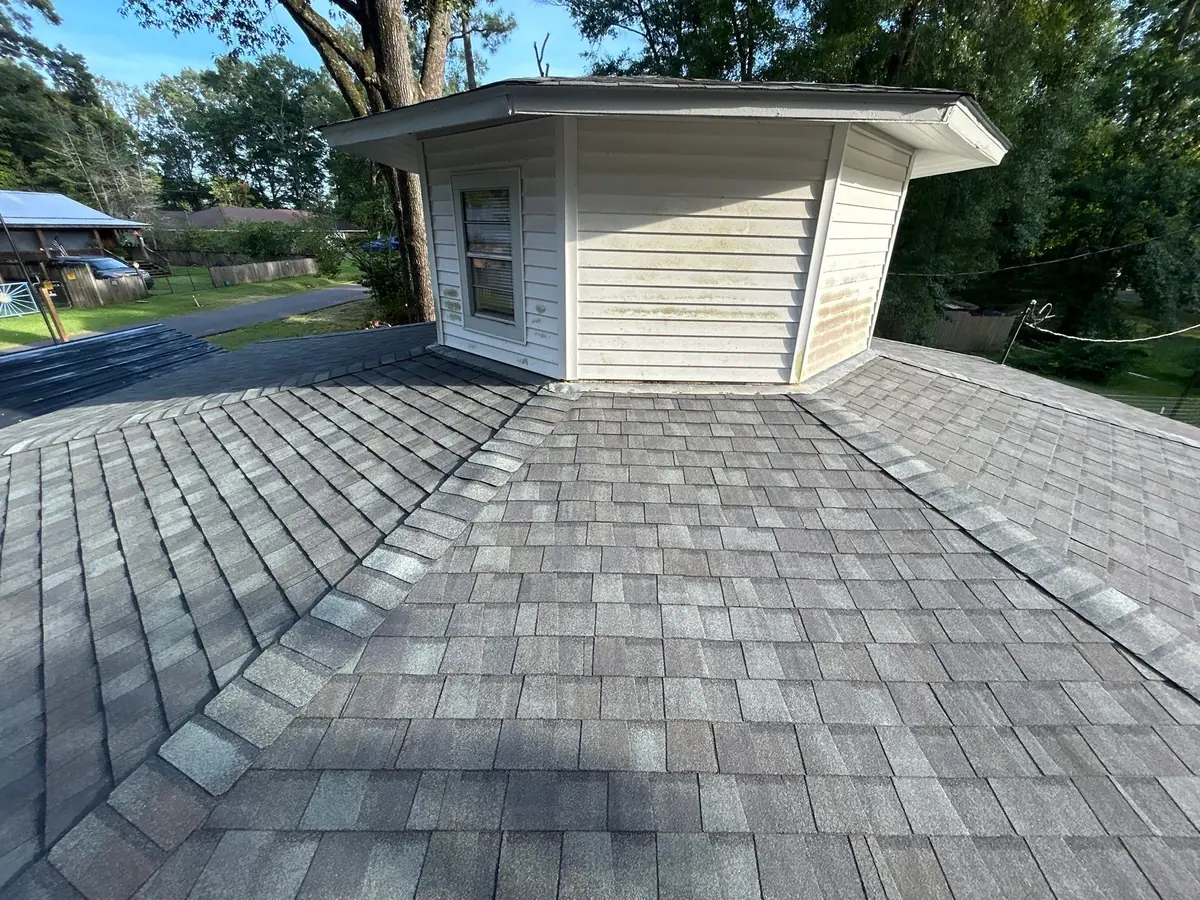 Finished Landmark shingle roof around a second-story bay with new hip caps