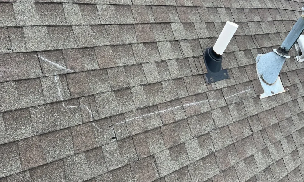 Architectural shingle roof with chimney and ridge cap in Zachary, Louisiana