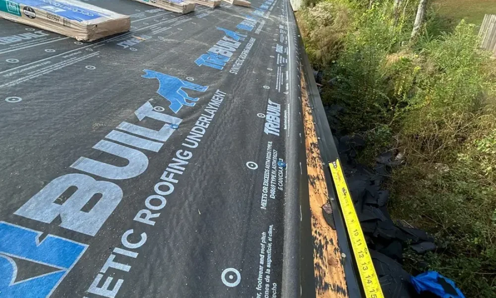 Synthetic underlayment and drip edge along the roof eave during a Greenwell Springs roof replacement