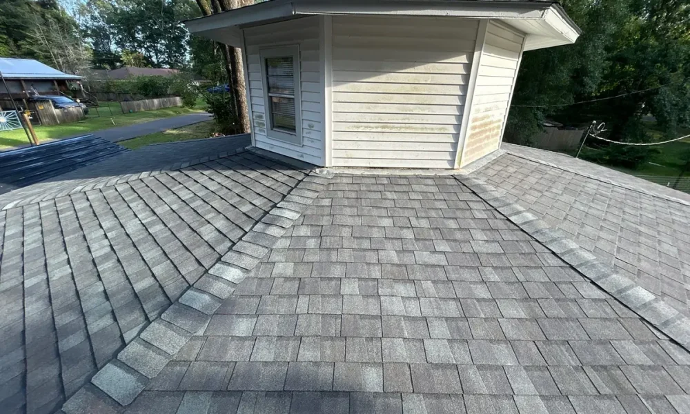 Finished Landmark shingle roof around a second-story bay with new hip caps