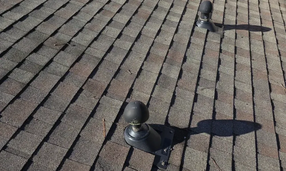 New flashing bases on two mushroom-cap roof vents after the repair in Baker