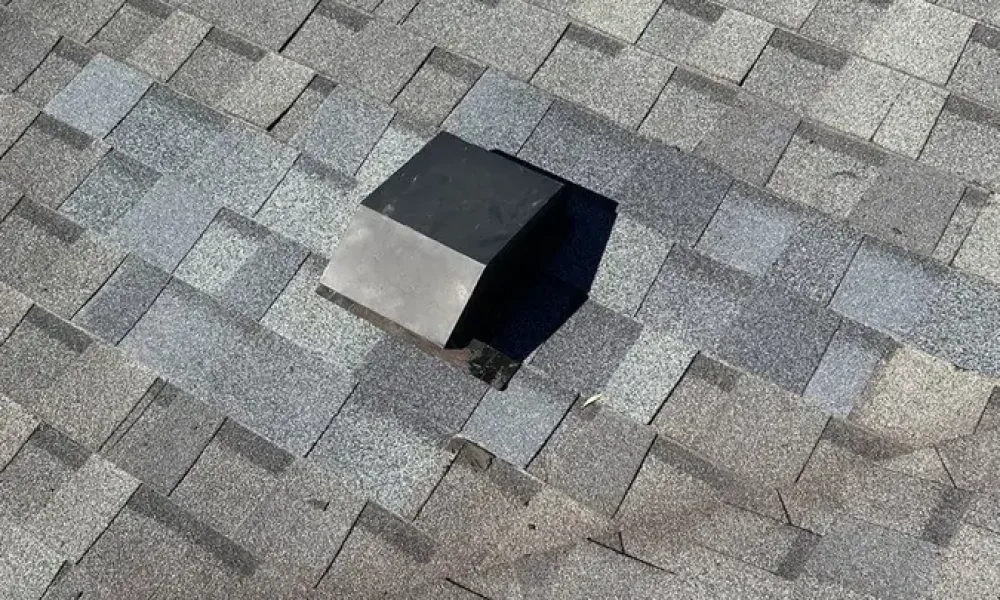 Box vent set in new shingles woven into the existing roof with no surface tar after a roof repair in Greenwell Springs, LA