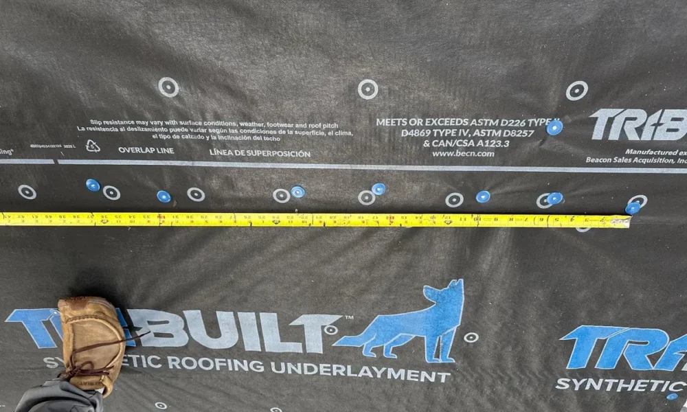 Synthetic roofing underlayment fastened over new decking during a Baker, Louisiana roof replacement