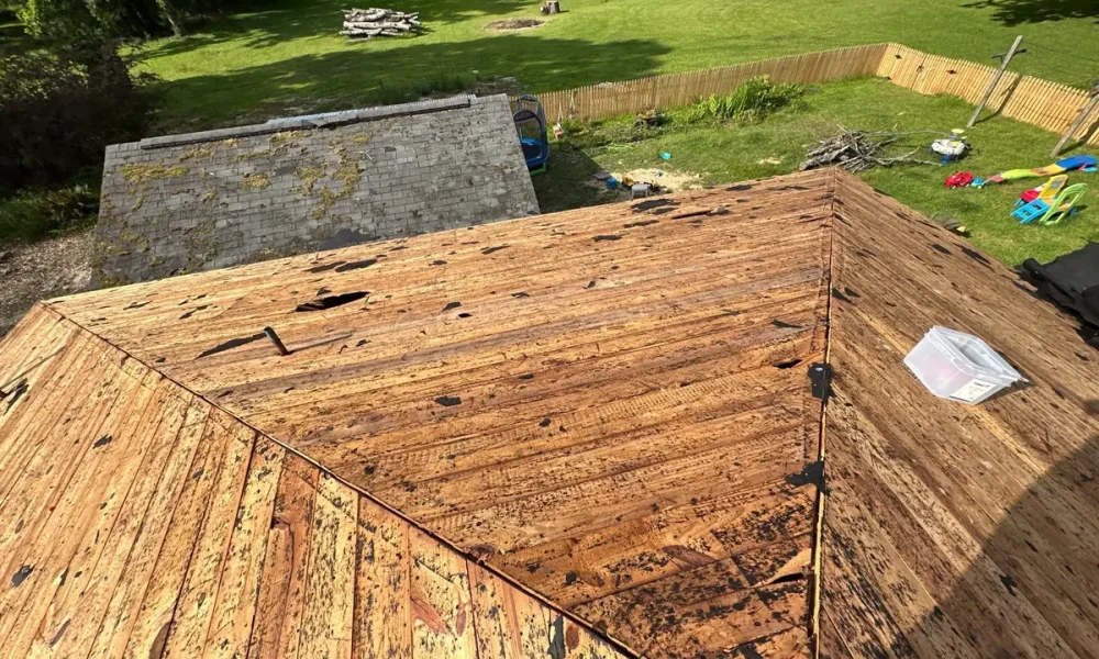 Roof stripped down to its original board decking after the old shingles came off the hip