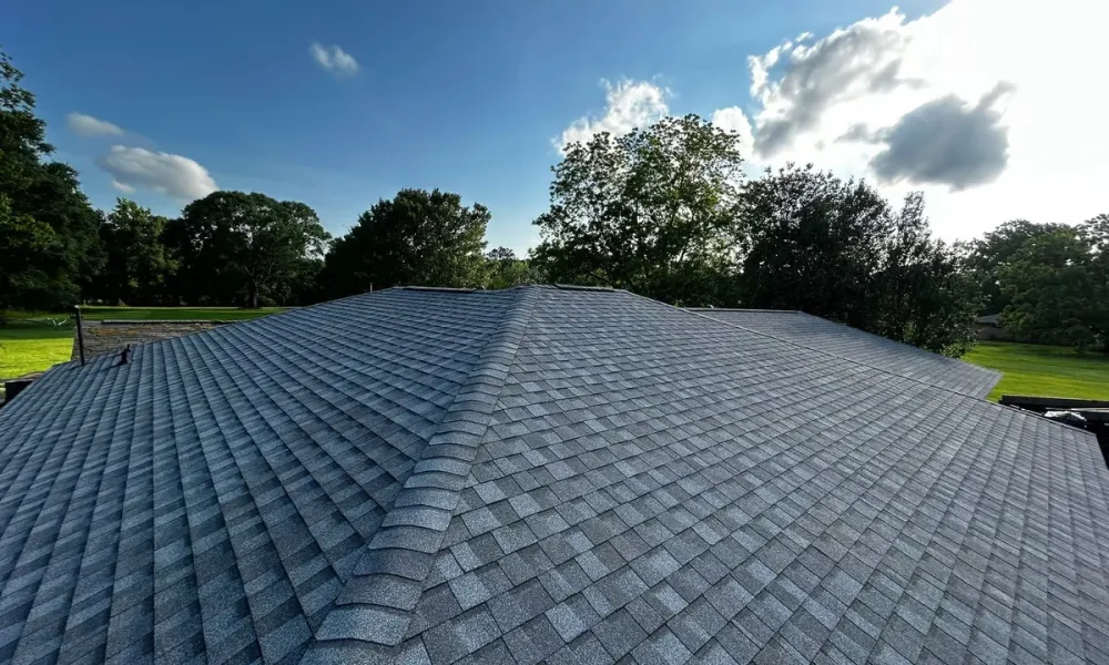 Finished roof in new architectural shingles under a clear sky after the one-day install in Slaughter, Louisiana