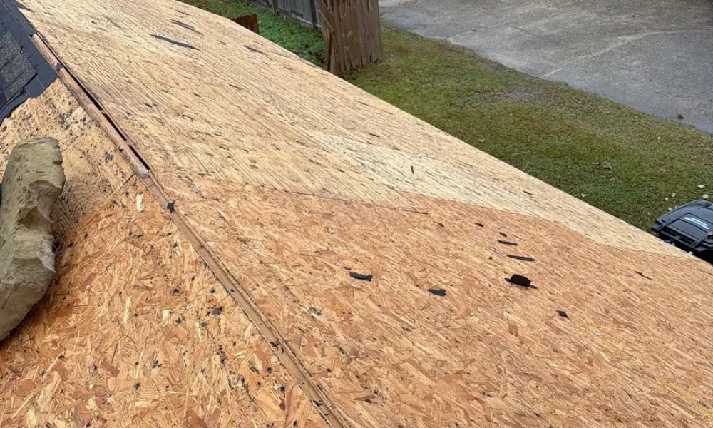 Bare roof decking exposed after full tear-off on a Central, LA roof replacement