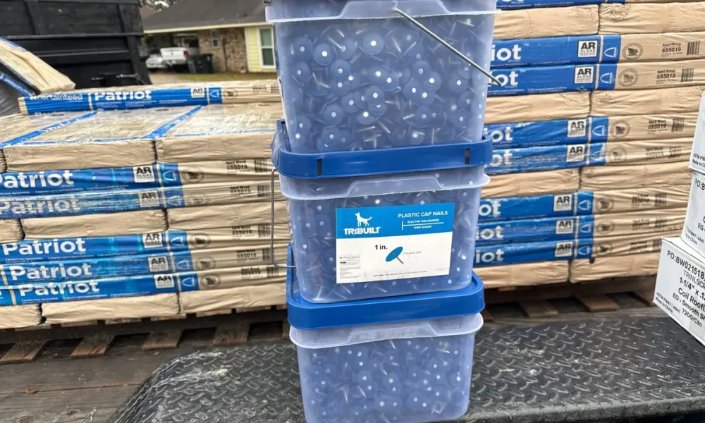 CertainTeed Patriot shingle bundles in Aged Wood staged on site with TRI-BUILT cap fasteners