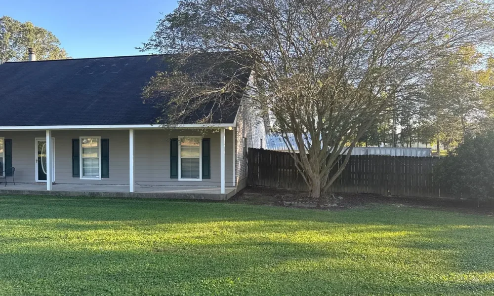 Ethel, Louisiana ranch home before the roof replacement, with the original dark, weathered shingles