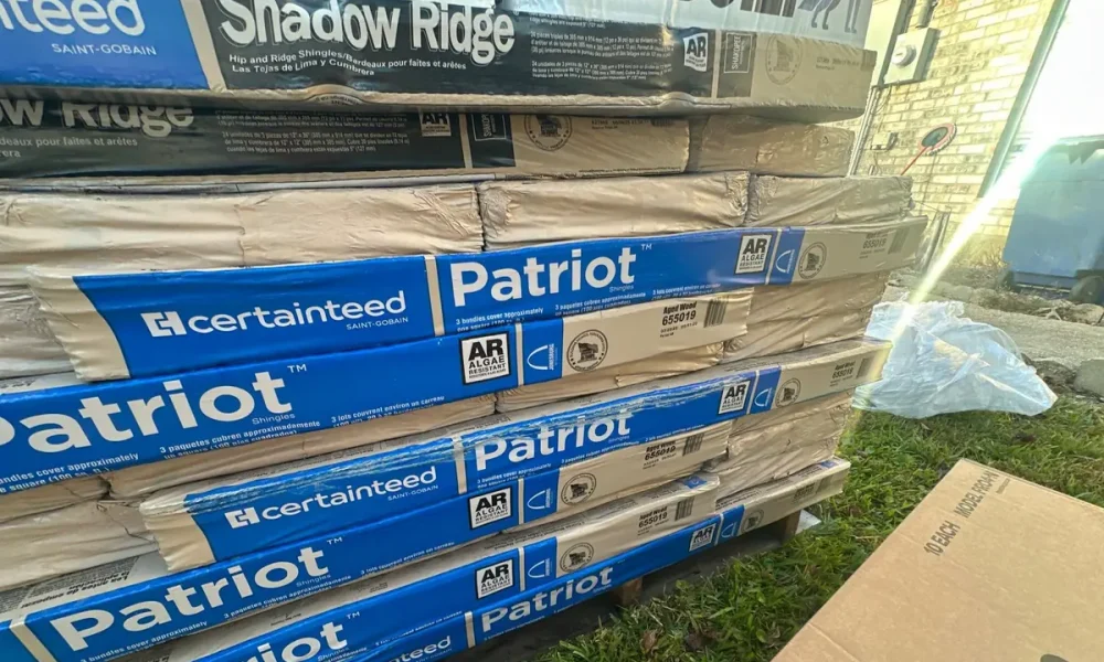 CertainTeed Patriot shingle bundles and Shadow Ridge hip and ridge staged on site in Ethel, Louisiana