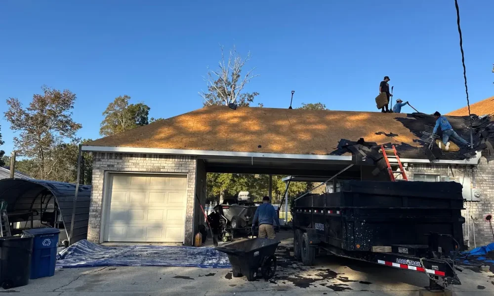 Tear-off underway in Ethel, with the old shingles loaded straight into a dump trailer at the driveway