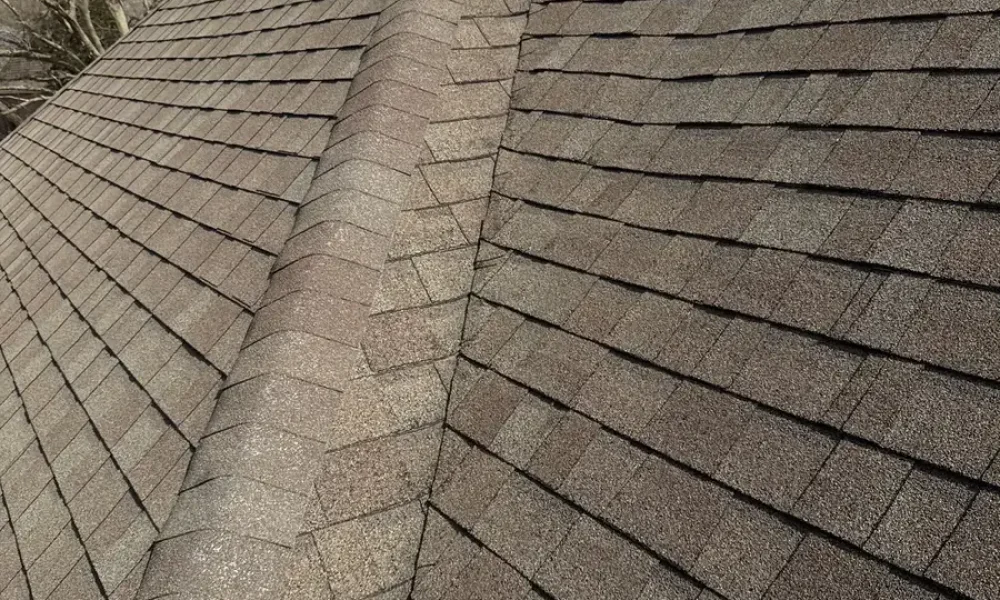 Worn hip and ridge on the original shingle roof of the Saint Gabriel home before tear-off