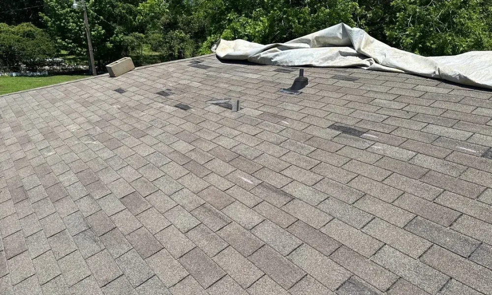 Tarp covering the storm-damaged section of the original roof in Slaughter, Louisiana