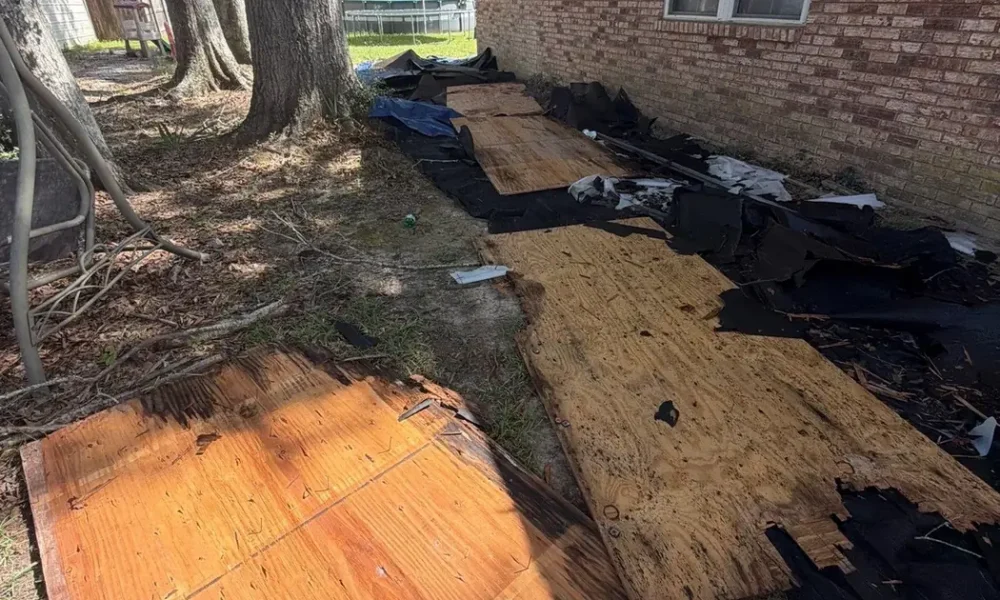 Old shingles torn off and roof decking exposed for inspection during a Zachary, Louisiana roof replacement