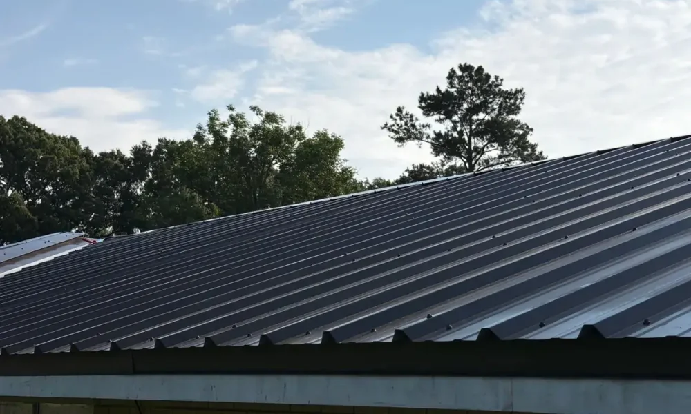 Dark metal roof panels running up to the ridge on a Central, LA home