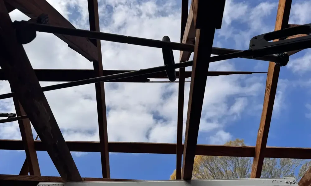 Daylight through the open rafters inside a Zachary, LA shop after the roof tore loose