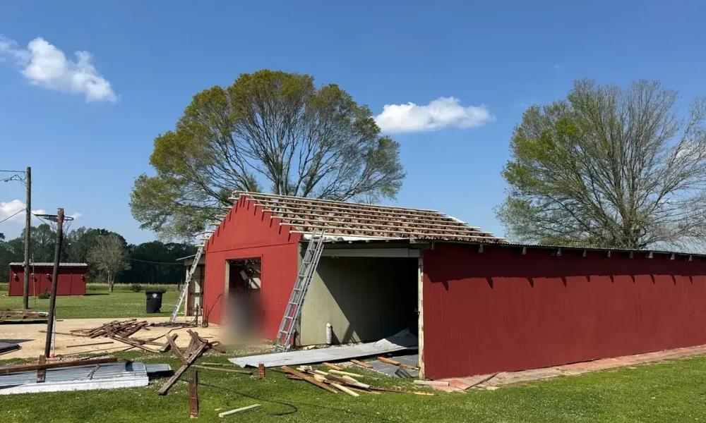 Zachary, LA shop stripped to the rafters with old metal roofing on the ground